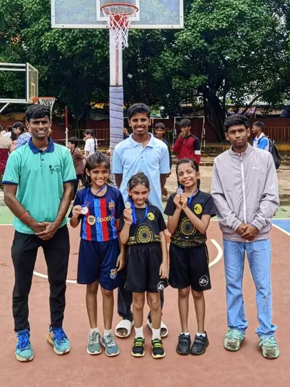 Celebrating our U-11 girls' basketball team who emerged as runners-up in their tournament. Posing with their medals and coaches, they show the rewarding results of their hard work.