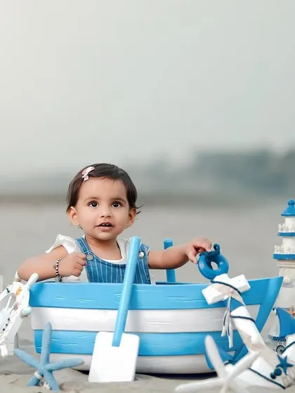 A sweet and simple portrait from a beach photoshoot. This little girl looks adorable and ready for adventure in her nautical-themed setup.