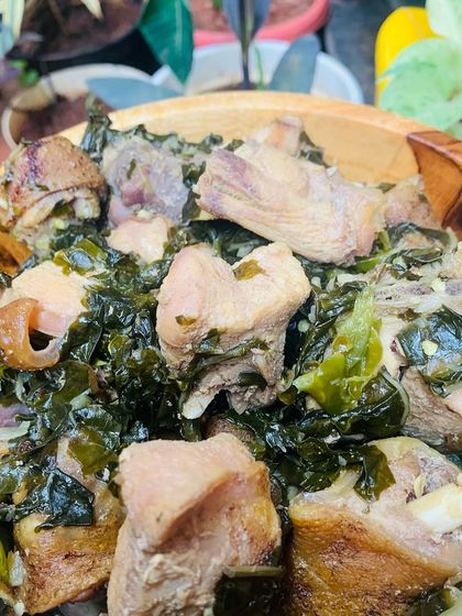 A close-up of the tender chicken pieces in the yam leaf curry.