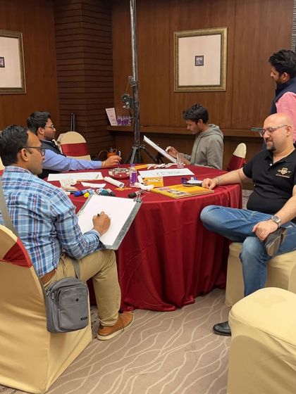 Here's my team and I set up and ready to draw at a large medical conference for over 250 professionals at the O Hotel in Pune. We can handle events of any size.
