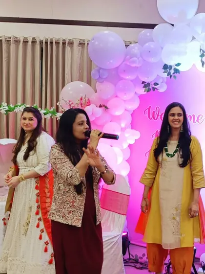 Interacting with the new mom and her family at a welcome baby party. It's all about making them feel celebrated and creating a warm, happy atmosphere for everyone.