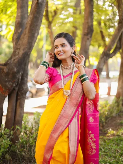 A joyful, candid moment with the bride. Her bright yellow and pink saree looks stunning in the natural light.