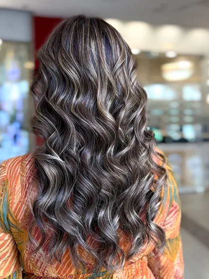 Another angle of this festive balayage, showing the beautiful blend of colors and the voluminous waves.