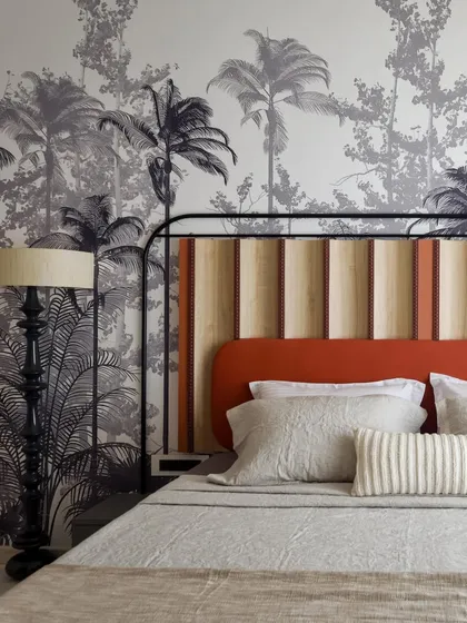 We love to tell a story through our designs. For this bedroom in 'A Den', we created a custom tropical wallpaper to reflect the client's love for plants and their South Indian roots. The bespoke headboard and handcrafted wooden floor lamp complete this personalized, nature-inspired escape.