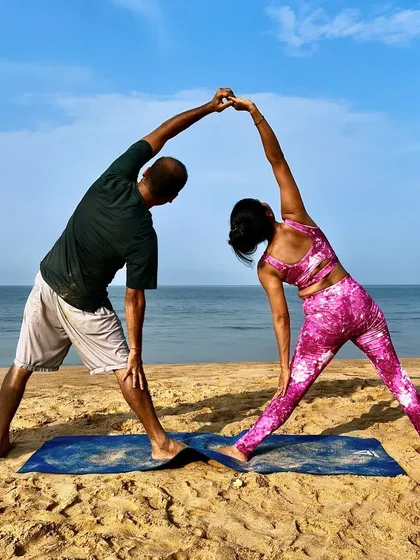 Trikonasana, or Triangle Pose, becomes a beautiful shared stretch in partner yoga. By holding hands, we can deepen the side-body stretch and find more stability in the pose together.