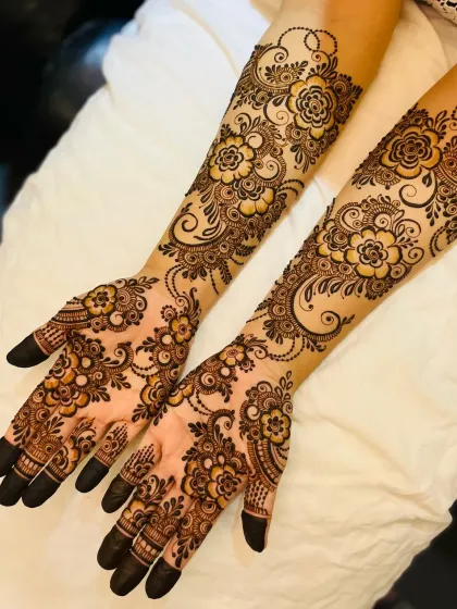 A beautiful floral vine design that flows from the palms up the arms. This style is perfect for brides who love delicate and flowing patterns.