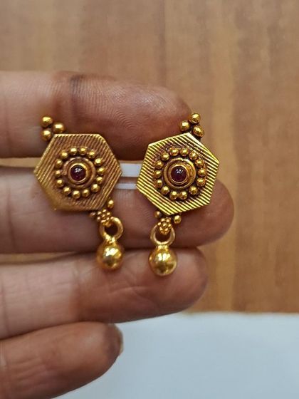 These hexagonal antique gold-plated earrings feature a small golden bead drop. They are lightweight and perfect for comfortable, all-day wear.