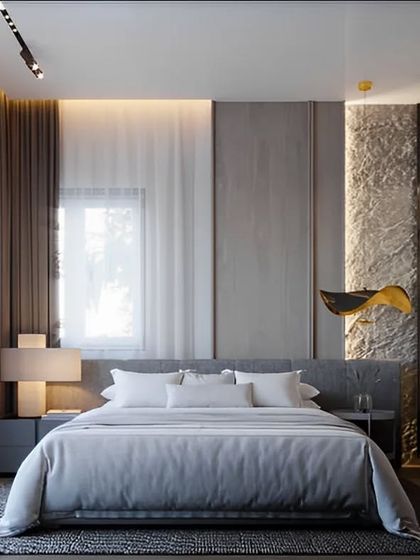 A serene and modern bedroom with a glass-walled walk-in closet. The combination of stone texture, soft fabrics, and warm lighting creates a balanced and tranquil environment.
