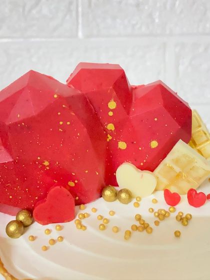 A close-up of the geometric heart toppers on our butterscotch anniversary cake.