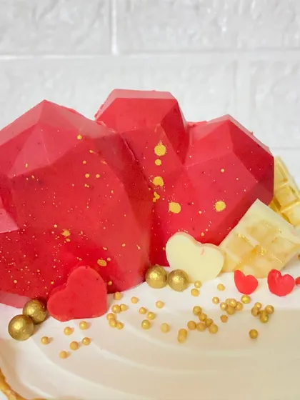 A close-up of the geometric heart toppers on our butterscotch anniversary cake.
