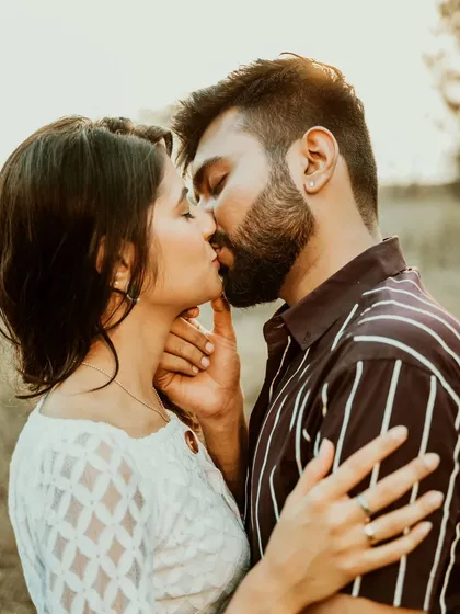 A passionate and intimate kiss captured in a close-up portrait. This photo is all about the raw emotion and deep connection between the couple.