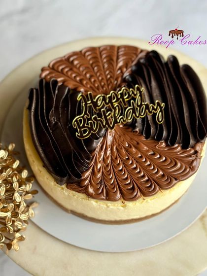 A delicious New York style baked cheesecake, topped with swirls of Nutella and dark chocolate ganache.