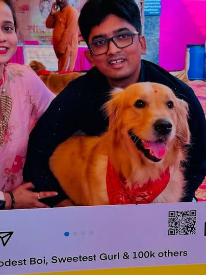 A close-up shot of Roger the Golden Retriever and his family posing inside the selfie frame, all smiles for the camera.