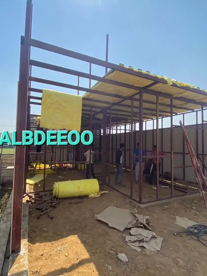 Work in progress on a G+1 prefabricated building in Meerut. The images show the MS frame being erected and glass wool insulation being installed in the roof.