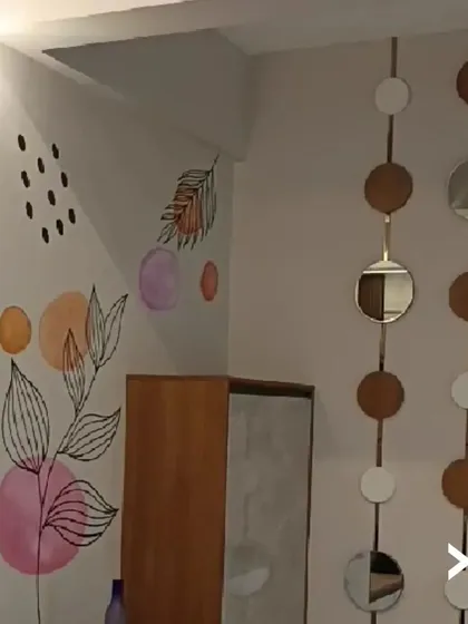 An example of our custom hand-painted mural work. For this corner, we created a free-flowing abstract botanical design using a soft color palette to add a touch of artistry and personality without overwhelming the space.