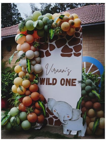 Another angle of our 'Wild One' entrance, showcasing the custom-designed welcome board and the creative use of balloons and foliage to create a lush, jungle-like feel.