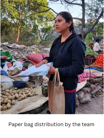 A volunteer hands out paper bags at a vegetable stall. These grassroots efforts are crucial for spreading awareness and making sustainable alternatives the norm in our community.