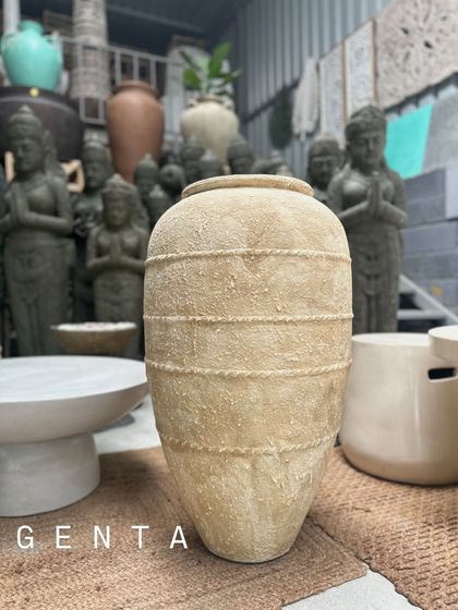 The 'Genta' planter features a subtle, lined texture on its surface, adding another layer of handcrafted detail to its neutral finish.