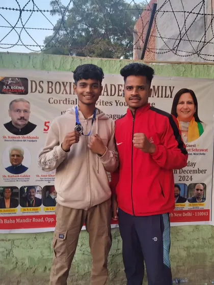 A student boxer and his coach celebrating a win. My coaching team is dedicated to the success of every fighter.