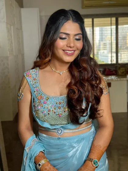 The client's smile says it all. This glamorous hairstyle is designed to make you feel confident and beautiful for your special event.