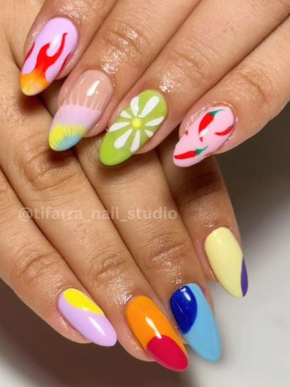 A burst of color and creativity. This vibrant set features a different hand-painted design on each nail, including flames, flowers, and chili peppers.