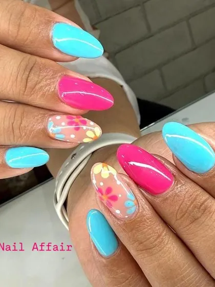 Brighten up your day with this vibrant floral nail art. The combination of turquoise, hot pink, and delicate hand-painted flowers on a sheer base makes for a perfect statement nail.