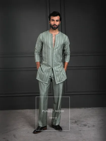 An expression of poise. Sage green woven into a royal ensemble, balancing tradition with modern sophistication. The loop buttons and vertical weave add depth without embellishment.