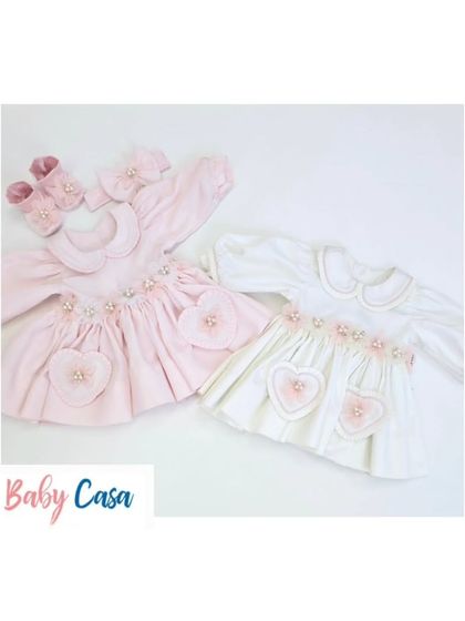 A pair of our sweet heart-themed dresses in pink and white. These outfits are perfect for sisters or for a baby's first photoshoot.