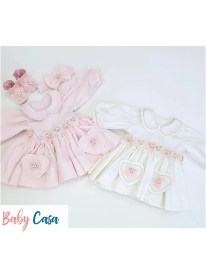 A pair of our sweet heart-themed dresses in pink and white. These outfits are perfect for sisters or for a baby's first photoshoot.