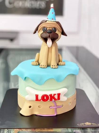 A cake for a furry friend! We created this adorable pug cake for a dog's birthday, complete with a party hat and an edible collar.