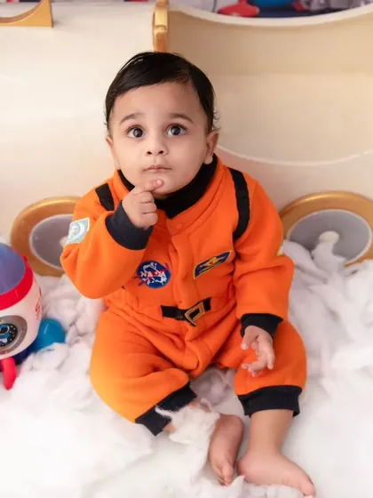 A curious little astronaut. This close-up captures his thoughtful expression as he explores the new world around him.