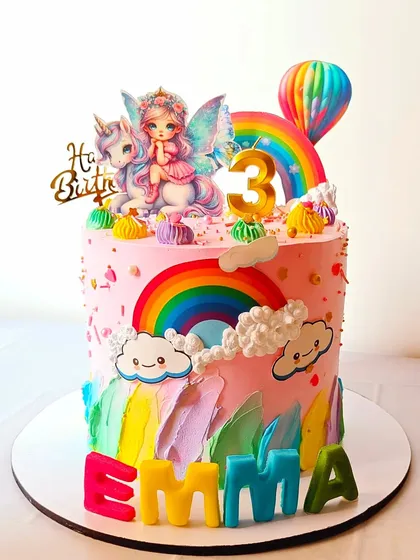 A whimsical unicorn and fairy-themed cake with vibrant rainbows and fluffy clouds. This design combines several magical elements for a truly enchanting birthday celebration.