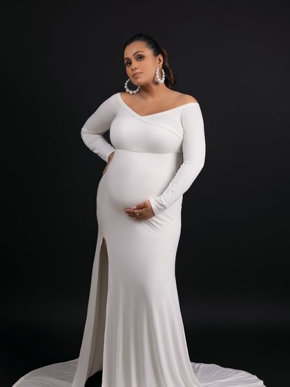 This pose, with the thigh-high slit, is both elegant and modern, celebrating the beauty of the female form.