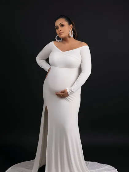 This pose, with the thigh-high slit, is both elegant and modern, celebrating the beauty of the female form.