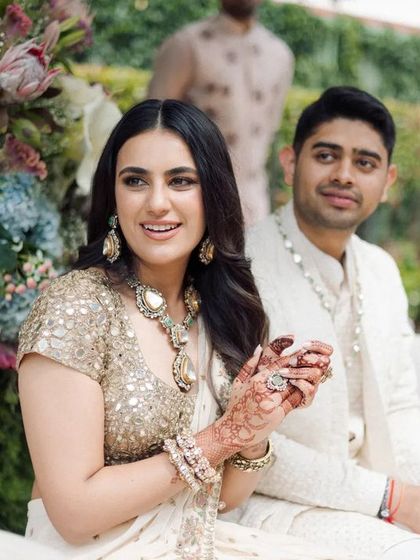 A candid shot of the couple during their engagement ceremony, surrounded by lush, locally sourced flowers.