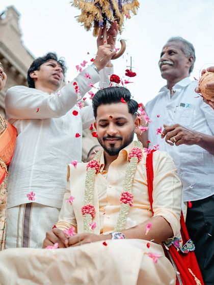 A groom being blessed by his family during a wedding ritual. We capture the joy and traditions that involve the entire family.