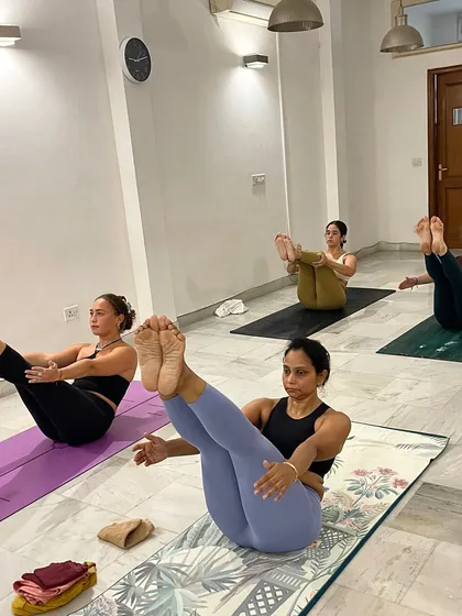 The challenge of Navasana (Boat Pose) is always better together. Our led classes foster a sense of shared strength and determination.
