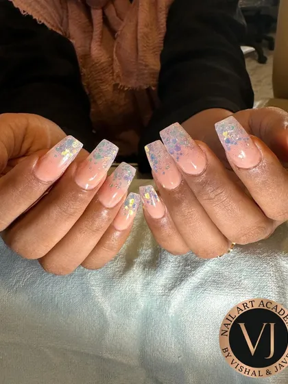 This is what our students can achieve. These elegant nude coffin extensions with a holographic glitter fade were created by a student, showcasing their skill in shaping, application, and finishing.