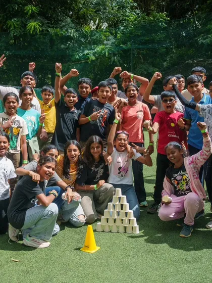 A group of young adventurers celebrating their win after a competitive and fun team building game.