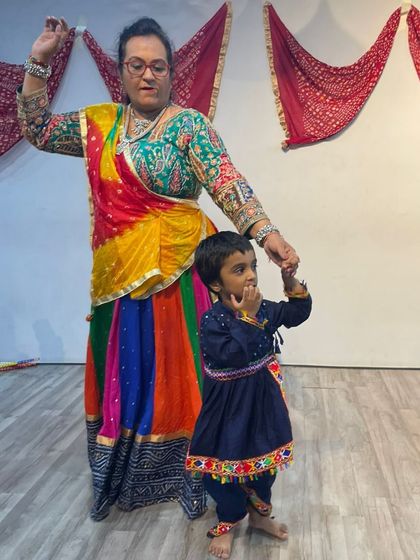 A mother and child, dressed in colorful traditional outfits, pose during our Navratri celebration. Our events are a wonderful way for families to share cultural experiences.