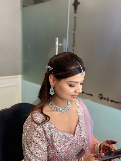 A candid moment of the bride-to-be during her engagement party. Her makeup looks fresh and radiant, designed to last through a long evening of festivities.