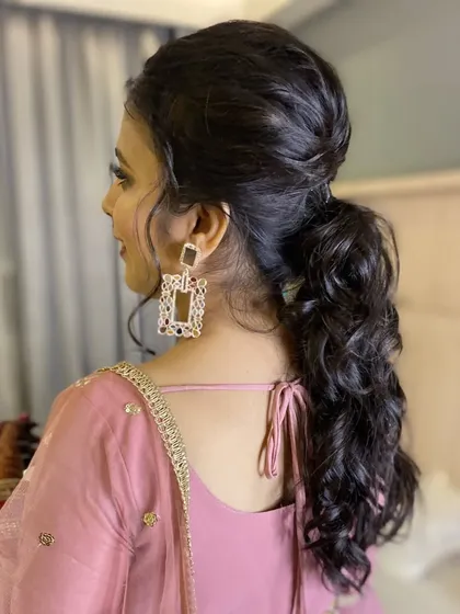 A side profile of the chic ponytail, showing the beautiful texture and volume created by my hair team.