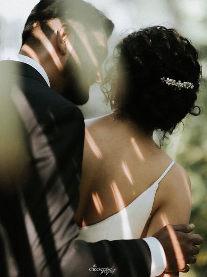 An artistic shot of the couple, with shadows creating beautiful patterns on the bride's back.