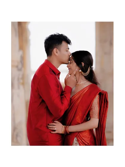 A tender forehead kiss, with the couple framed in a square format, highlighting their intimacy.