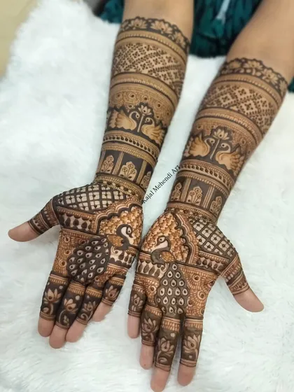 This is the kind of intricate, full-arm bridal mehndi I love to create. Every element, from the delicate peacocks to the fine jaali work, is drawn with care using my own organic henna to celebrate your special day.