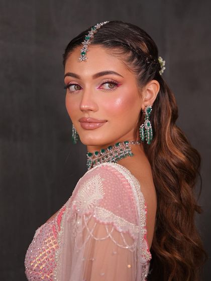 A side profile showing the fresh, dewy skin and the subtle yet impactful pop of pink in the eye makeup.