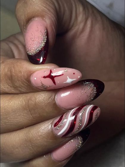 A close-up of the detailed Christmas nail art, showing the fine lines in the candy cane design and the sparkling star accent.