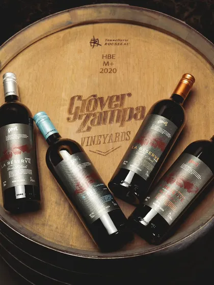 The La Réserve collection, displayed here on a barrel top, represents timeless elegance in every bottle. This range is a tribute to our legacy, tradition, and the art of blending, a cornerstone of the Grover Zampa heritage.