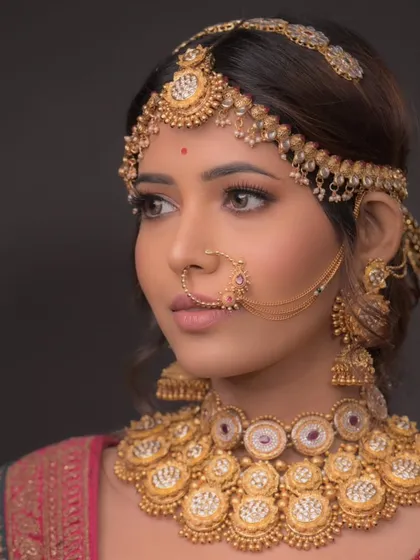 This angle highlights the intricate matha patti and the bold, defined eye makeup.