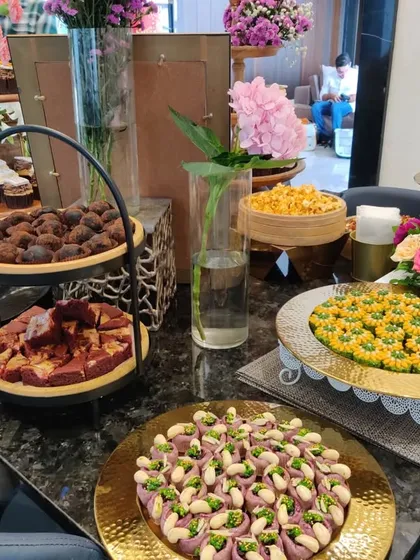 A close-up of the dessert section of a housewarming grazing table. We included a variety of sweets, from rich chocolate truffles to traditional Indian mithai, offering something for every sweet tooth.